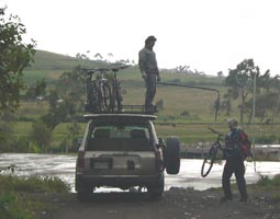 loading the bikes on the SUV in the rain