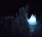 Stalagmites with light behind one