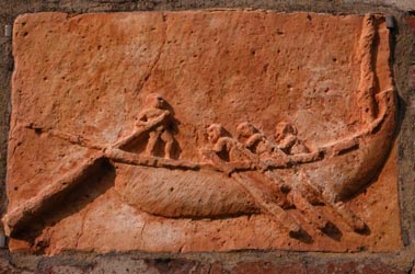 Detail of a carving of men on a boat