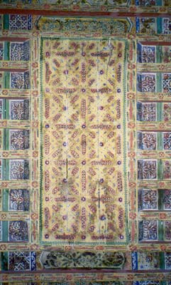 ornate ceiling in yellwos, blues, and green