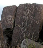 Petroglyphs on a rock several feet tall