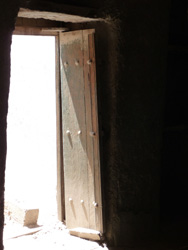 Rugged wooden door to an abandoned home