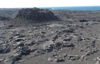 Volcanic cone on rough land