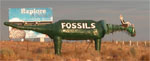 Green dinosaur on the side of the road advertising Fossils