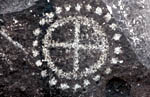 Petroglyph cross in a circle with dots around the circumferance