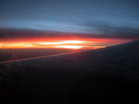 Sunset over plane wing